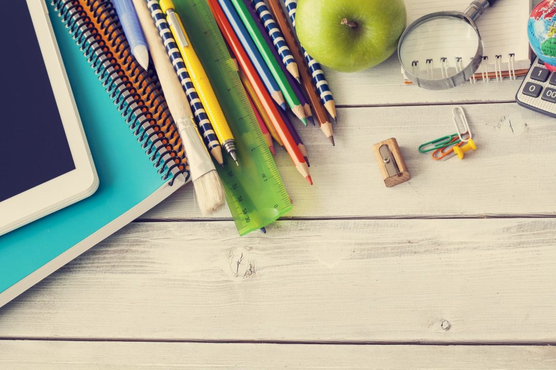 Collection of teacher supplies and stationery on a desk